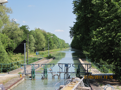 The lock has been filled, soon the gates will open. The exit of lock 63 is on a pont-canal, a bridge which carries the canal over a stream or river.