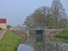 The misty morning view from that mooring, of Lock #55, Lucy. The lock is not yet ready for service, as indicated by the single closed gate.