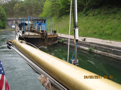 The tug pulls itself along a chain at the bottom of the canal.